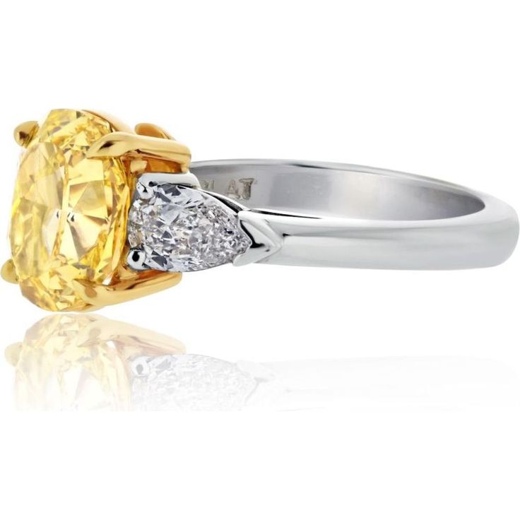 Immerse in the elegance of artistry and innovation with this exquisite 18K Yellow Gold 2.53ct Fancy Vivid Yellow Oval Diamond Three Stone Ring. Crafted to perfection, this ring features a breathtaking 2-carat oval-cut Fancy Vivid Yellow diamond at its center, radiating warmth and sophistication. Flanking the center stone are two pear-cut diamonds totaling 0.60 carats, adding a touch of brilliance and enhancing the overall allure of this timeless piece.The vivid yellow hue of the center diamond is accentuated by the rich 18K yellow gold setting, exuding luxury and charm. The platinum accents further elevate the design, ensuring durability and longevity. Whether it's a symbol of love, a milestone celebration, or a statement of personal style, this ring is sure to captivate hearts and leave a Yellow Oval Brilliant Cut Diamond Ring, Luxury Yellow Oval Sapphire Ring, Luxury Yellow Pear-shaped Ring, Elegant Yellow Pear-shaped Diamond Ring, Yellow Oval Sapphire Diamond Ring, Oval Yellow Sapphire Ring With Diamonds, Luxury Yellow Oval Rings, Elegant Yellow Oval Sapphire Ring, Yellow Oval Sapphire Ring With Prong Setting