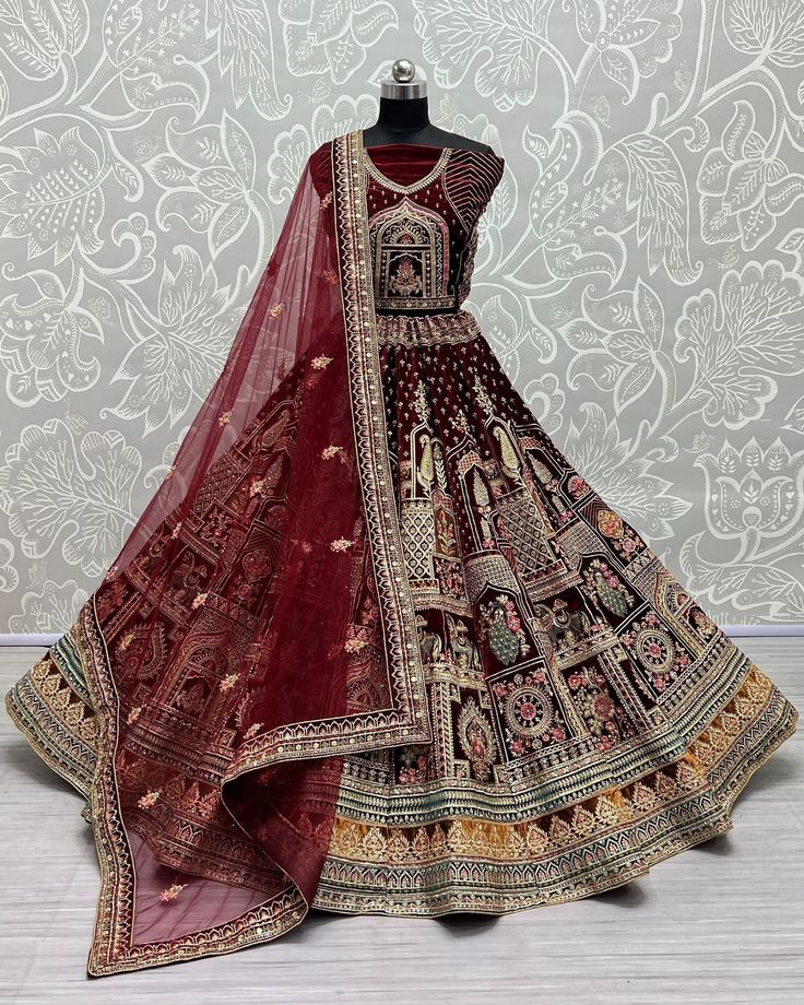 About Product : Allure the audience adorning this maroon colored velvet lehenga crafted with Diamond work embroidery all over enhanced by pearls embellishment. Comes along with a matching colored velvet choli that features round neckline and quarter sleeves, and a maroon colored net dupatta, both in similar embroidery .  Lehenga Choli Fabric:  Lehenga Fabric:- Velvet  Blouse Fabric:-  Velvet  Dupatta Fabric:-  Soft Net  Work :- Embroidery,Zari,Sequence And Diamond Work   Size : Free Size Up to 4 Bridal Velvet Lehenga, Maroon Bridal Lehenga, Velvet Bridal Lehenga, Velvet Lehenga Choli, Velvet Dupatta, Dori Work, Lehenga Choli Designs, Bridesmaid Lehenga, Bridal Lengha