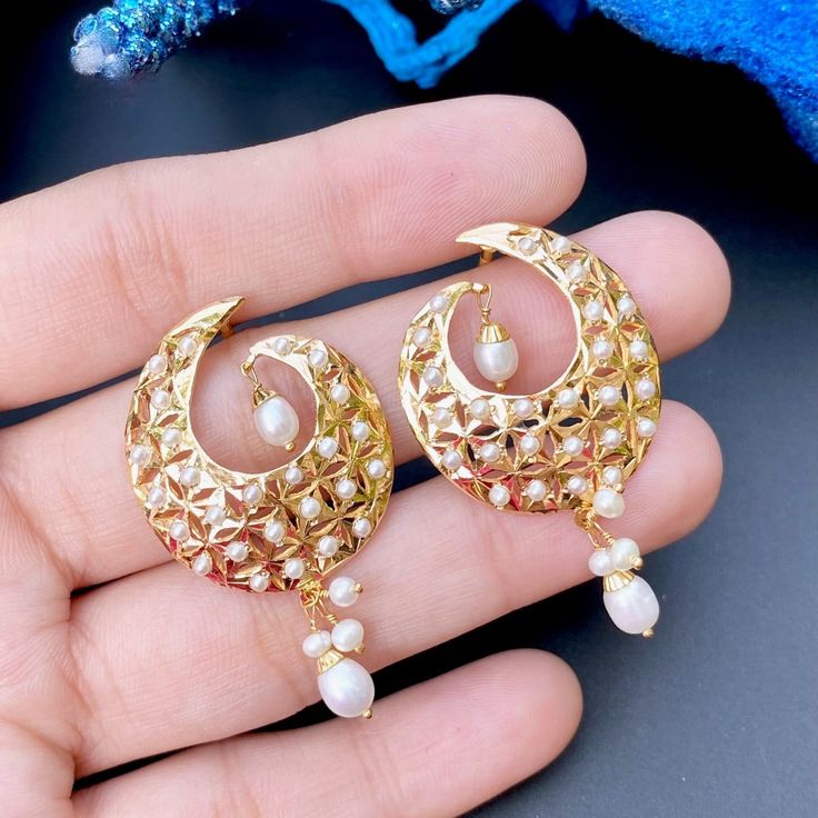 These stunning 8.94 GM pearl earrings, designed in 22ct gold and featuring 0.70 GMs of hanging beads, provide a timeless beauty. Delicately crafted and perfect for any important event, they will add a sophisticated touch to your style. Watch Video Here Wedding 22k Gold Danglers, 22k Gold Chandbali Bridal Earrings For Pierced Ears, 22k Gold Chandbali Earrings For Anniversary, Gold Fusion Danglers For Anniversary, Gold Plated Pearl Drop Temple Earrings, White Chandbali Earrings With Elegant Design, Festive Gold Hoop Earrings With Pearl Drop, Gold Plated Chandbali Earrings For Anniversary, White Chandbali Fusion Earrings