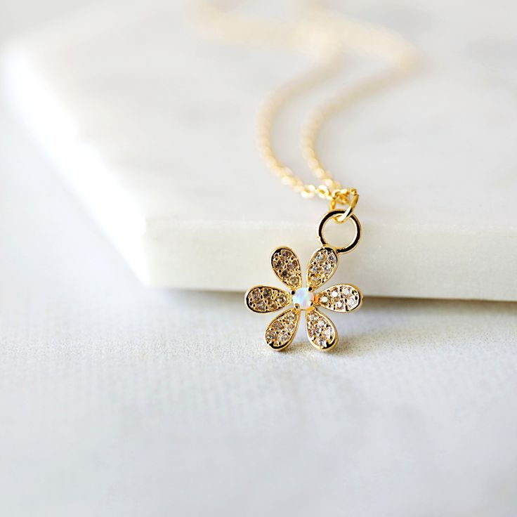 "Beautiful and lovely tiny gold flower necklace. Made of cubic and tiny opal stone gold flower with skinny gold chain. Soft and warm-looking dainty necklace is good for yourself or gift ! Your necklace will ship in a rudiana gift box. * Gold plated over brass * Opal stone / CZ * Length available 15\"-20\" * Flower pendant 3/8\" * Creation Time: 1 - 3 days ♥ See more Rudiana Accessories Rudiana.etsy.com" Gold Flower Necklace, Necklace Opal, Opal Pendant Necklace, Gift Flower, Expensive Jewelry, Stone Gold, Opal Stone, Jewelry Stand, Gold Flower