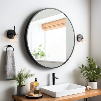 a bathroom with a sink, mirror and potted plants on the counter in front of it