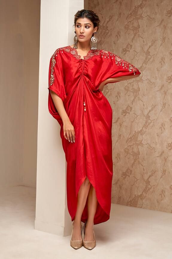 Red kaftan with thread embroidery on the shoulder, sequin latkans and center front drawstring.
Components: 1
Pattern: Embroidered
Type Of Work: Thread, Sequin
Neckline: V Neck
Sleeve Type: Asymmetric
Fabric: Silk
Color: Red
Other Details: 
Center front drawstring
Weight: Approx 500 gms
Length: 52 inches
Model height: 5 ft. 7 inches, wearing size S
Occasion: Resort, Party - Aza Fashions Red Kaftan, Resort Party, Kaftan Pattern, Kaftan Women, Kaftan For Women, Red Thread, Thread Embroidery, Fabric Silk, Red Silk