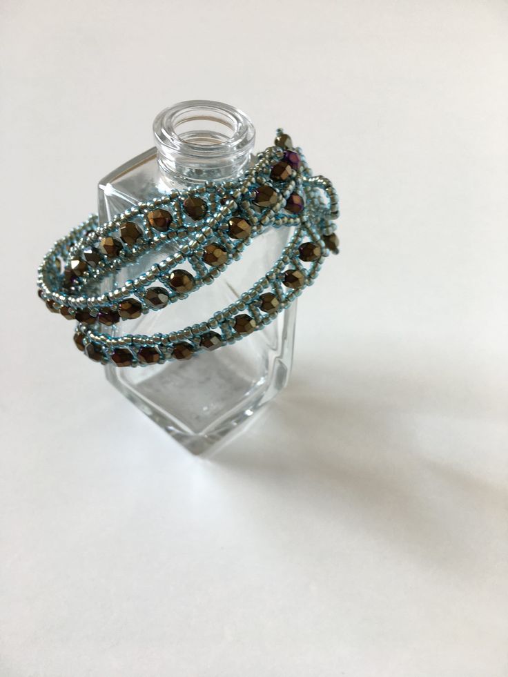 This beautiful blinking and elegant bracelet will be a great addition to your accessories, suitable for casual and evening wear. Perfect gift for every women. Each glass bead is threaded with needle one bead by one. To make this bracelet I use high quality glass beads, polished glass crystals and durable thread. Also have a handwoven toggle closer. If you want a gift wrap, just let me know. It comes in black gift box and tied with riband. Bracelet size: length: fits for 17-19 cm  width: 3 cm To Elegant Crystal Bangle As A Gift, Bohemian Crystal Beaded Bracelets For Jewelry Making, Bohemian Crystal Bracelet With Faceted Beads As Gift, Gold Crystal Bracelets With Colorful Beads, Handmade Adjustable Bangle For Parties, Bohemian Crystal Bracelet For Gift, Bohemian Crystal Bracelet Gift, Hand Wrapped Bracelet Jewelry For Party, Elegant Wire Wrapped Crystal Bangle Bracelet