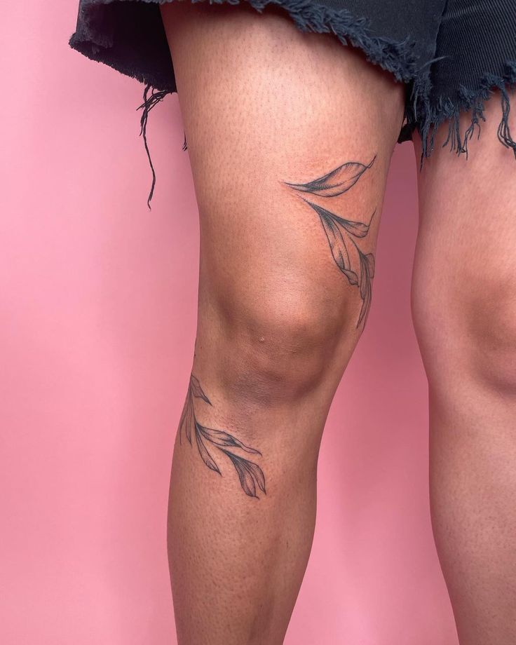 the legs and thighs of a woman with tattoos on her body are shown in front of a pink background