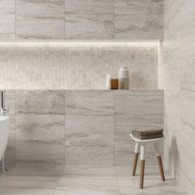 a white bath tub sitting next to a wooden stool