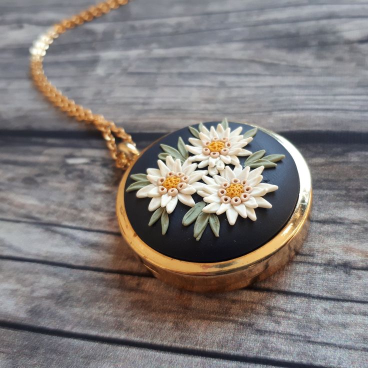 Mothers Day Locket Necklace, Mothers Day Gift, Mothers Day Keepsake FREE FEDEX priority shipping takes: 2-3 WORKDAYS ( USA). This is a vintage style, unique, handmade, polymer clay locket necklace with edelweiss flowers motif. This beautiful romantic, photo locket necklace is a piece of original and unique artwork. It's a perfect gift idea for mom, for wife. The base of the locket is gold color, brass alloy. The photo locket is openable, you can insert a picture or some small souvenir from your Pendant Locket Jewelry Gift For Mom, Mother's Day Gift Locket Necklace With Vintage Charm, Pendant Locket Jewelry As Gift For Mom, Vintage Charm Locket Necklace With Flower Pendant For Gift, Mother's Day Flower Pendant Locket Necklace Gift, Vintage Charm Necklace For Mother's Day Anniversary, Vintage Charm Necklaces For Mother's Day Anniversary, Vintage Charm Necklaces For Anniversary And Mother's Day, Vintage Charm Round Necklace For Gift