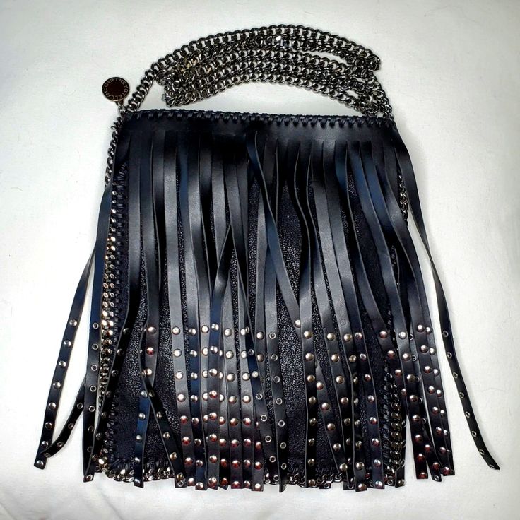 Elevate Your Style With This Chic And Eco-Conscious Stella Mccartney Crossbody Bag. Made From Premium, Cruelty-Free Materials, This Fabulous Bag Perfectly Blends Sustainability With Modern Fashion. The Fun Design Features Black Fringes With Studs And A Chain Strap, Making It Perfect For A Night Out Or A Rock Concert! - Color: Black - Material: Vegan Leather - Strap: Metal Chain - Interior: Includes A Large And Small Compartments - Condition: New With Tags Add This Stella Mccartney Crossbody To Y Edgy Black Bag With Silver-tone Hardware, Edgy Black Bags With Silver-tone Hardware, Edgy Black Shoulder Bag With Palladium Hardware, Edgy Rectangular Shoulder Bag For Evenings, Luxury Fringe Shoulder Bag For Party, Edgy Rectangular Evening Bag, Edgy Party Bags With Chain Strap, Black Edgy Bags With Palladium Hardware, Edgy Black Bags With Palladium Hardware