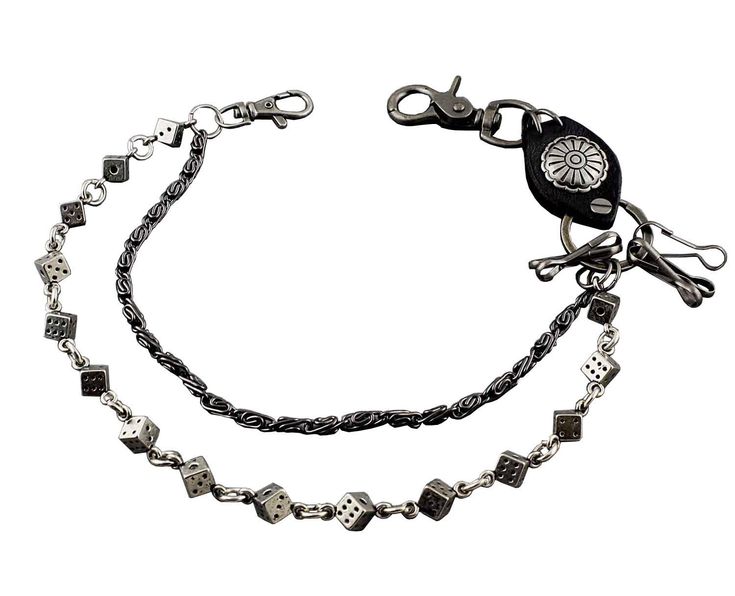 a black and silver chain with dice charms on it's ends is attached to a white background