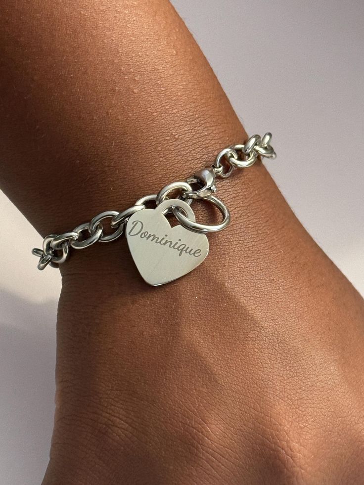 Delight in the timeless elegance of the Personalized Stainless Steel Heart Bracelet, a perfect accessory for any occasion. Constructed from 316L Surgical Grade Stainless Steel, this bracelet is designed to withstand daily wear without tarnishing or causing skin discoloration. It is water-resistant, making it ideal for wearing in the shower or pool. Available in 7-inch and 8-inch lengths and measuring 1/4 inch wide (7mm), it ensures a comfortable fit for everyone. Features: Material: Made from 316L Surgical Grade Stainless Steel that won't tarnish or turn skin green, ensuring long-lasting wear and durability. Lengths: Available in 7-inch and 8-inch lengths to provide a perfect fit for every wrist. Width: The bracelet measures 1/4 inch wide (7mm), offering a sleek and elegant look. Heart Cha Trendy Metal Bracelets For Mother's Day, Trendy Silver Bracelet For Wedding, Trendy Silver Wedding Bracelet, Trendy Engraved Silver Jewelry, Trendy Silver Heart Bracelet For Gift, Trendy Stainless Steel Jewelry For Anniversary, Elegant White Gold Charm Bracelet For Mother's Day, Trendy Silver Heart Bangle Bracelet, Elegant Bracelets With Heart Charm For Promise