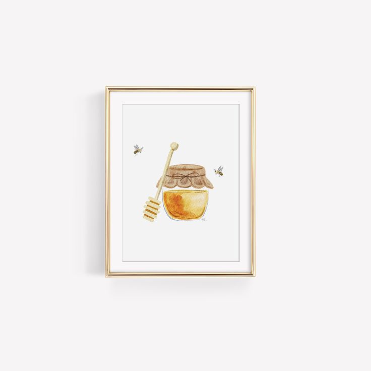 a framed print with a honey jar and beehive on it, in front of a white wall