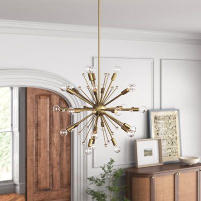 a chandelier hanging from the ceiling in a room with wood floors and white walls