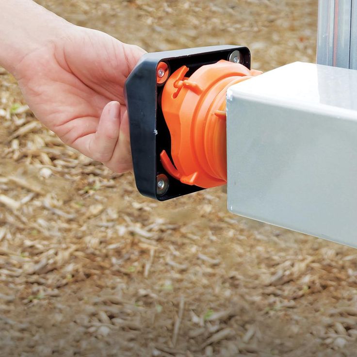 a person is holding an orange object in their hand and it's attached to a white box