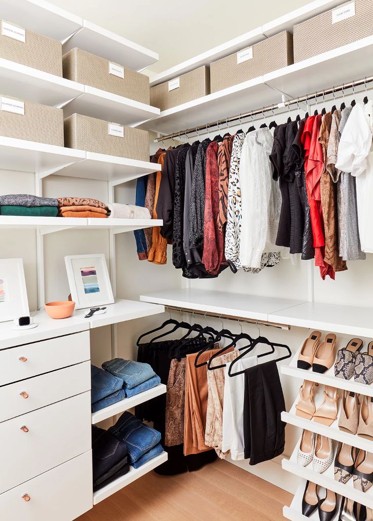 an organized closet with clothes and shoes