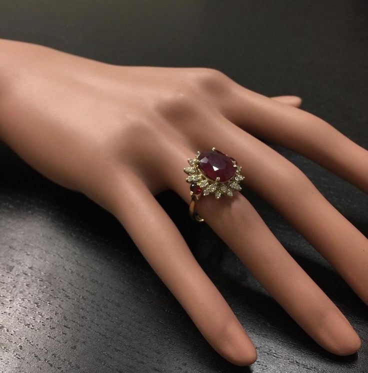 6.00 Carats Impressive Red Ruby and Diamond 14K Yellow Gold Ring Suggested Replacement Value $4,800.00 Total Red Ruby Weight is: 5.25 Carats (glass filled) Ruby Measures: 12.14 x 9.65mm Natural Round Diamonds Weight: .75 Carats (color G / Clarity SI1) Ring total weight: 5.8 grams Disclaimer: all weights, measurements and colors are approximate and may vary slightly from the listed dimensions or as seen in the image. All pictures are magnified to show the smallest of details. Please, refer to the Luxury Ruby Cluster Ring, Ruby Ring For Parties, Party Ruby Ring Round Shape, Luxury Red Cluster Diamond Ring, Ruby Ring For Party, Round Shape, Elegant Ruby Ring With Diamond For Party, Red Diamond Ring For Formal Occasions, Luxury Red Pear-shaped Jewelry, Classic Red Cluster Diamond Ring