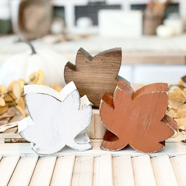 three wooden leaves sitting on top of a table