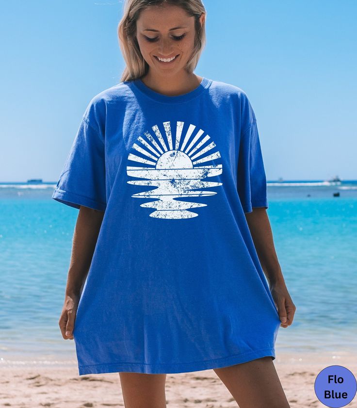 ☀️Discover our Retro Sunshine Comfort Colors summer beach vacation shirt!☀️  This trendy Sun Rays t-shirt features an eye-catching White Distressed graphic design that is sure to enhance your next beach vacation! Made of 100% ring-spun ethically grown cotton, this shirt is super soft and comfortable. It has a relaxed fit which is made of a medium fabric that is preshrunk. Looks super cute with shorts, jeans or as an oversized beach cover up. Great gift for a Beach Lover! Comes in 9 pretty colors Cheap Palm Tree Print T-shirt For Beach Season, Blue Summer T-shirt For Surfing, Summer Short Sleeve T-shirt For Warm Weather, Tropical Graphic Print T-shirt For Beach, Casual Beach T-shirt For Warm Weather, Blue Summer T-shirt For Vacation, Blue Short Sleeve T-shirt For Beach Season, Blue Short Sleeve T-shirt For Beach, Blue Short Sleeve Summer T-shirt