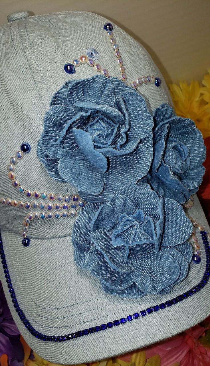 Light blue hat with shades of dusty blue 3D flowers accented with dark blue diamond rhinestones and white colored AB pearls. ONE SIZE FITS ALL Colors, hues and shades vary with each photo. Truckers Hats, Shades Of Dusty Blue, Flower Outfit, Hats Ideas, Hat Burning, Diy Wings, Denim Bag Patterns, Upcycled Jeans, Mad Hatter Hats