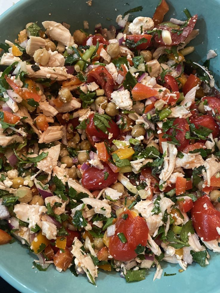 a blue bowl filled with lots of food