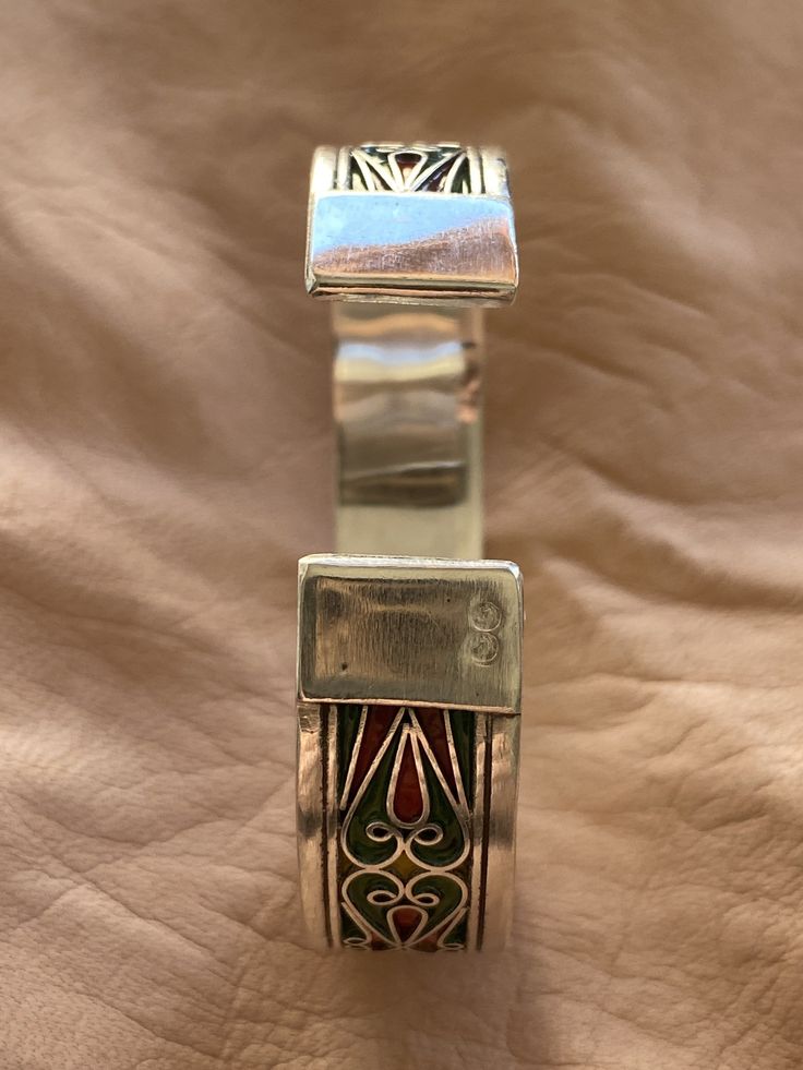 "This is a great silver and enamel cuff bracelet from Morocco. It measures just under 5/8\" (1,45 cm) at the widest and the inner diameter is just over 2 3/8\" (6,1 mm) wide. It is slightly adjustable as it is a cuff style bracelet. The bracelet features fantastic filigree-style wirework with unique-colored enamel." Silver Bohemian Bracelets With Inlay, Traditional Adjustable Enamel Bracelets, Traditional Adjustable Cuff Bracelet With Inlay, Traditional Inlay Cuff Bangle Bracelet, Artisan Silver Cuff Bracelet With Inlay, Silver Inlay Cuff Bracelet Bangle, Traditional Adjustable Inlay Cuff Bracelet, Bohemian Silver Cuff Bracelet With Inlay, Silver Bohemian Cuff Bracelet With Inlay