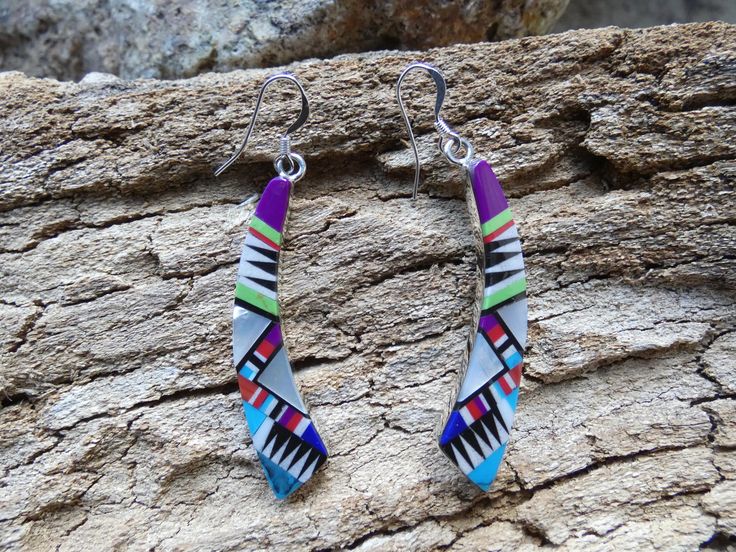 This is a beautiful handcrafted STERLING SILVER 925 pair of earrings. They are a nice size and on Sterling Silver french wire hooks. The back of these earrings are all Sterling Silver and stamped. What makes these earrings stand out is the gorgeous mix of vibrant gemstones unique design. Turquoise, Sugilite, Gaspeite, Onyx, Coral, Lapis and Mother Of Pearl. It is hard to capture the beauty of these vibrant gemstones though a camera. These are perfect for someone that enjoys color and a unique design. The size of earrings make them a perfect weight for all day wear. For EXACT measurements please look at the pictures. FREE Gift Bag. FREE Shipping in the USA.  Ground Advantage with tracking shipping is FREE. If you need it faster you can select priority shipping during the check out. Buy with Multicolor Sterling Silver Earrings For Gift, Nickel-free Multicolor Sterling Silver Earrings, Multicolor Sterling Silver Nickel-free Earrings, Multicolor Sterling Silver Drop Earrings, Multicolor Sterling Silver Ear Wire Jewelry, Unique Multicolor Sterling Silver Earrings, Handmade Southwestern Sterling Silver Earrings, Southwestern Style Drop Earrings As Gift, Inlay Drop Earrings Jewelry Gift