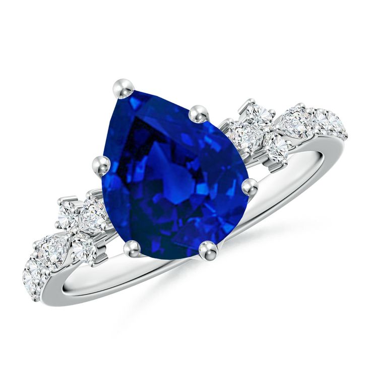 an oval blue sapphire and diamond ring with three stone side stones on the band, set in 18k white gold