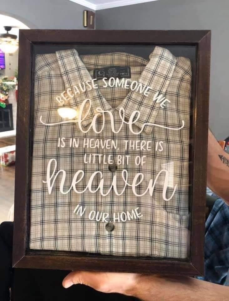 a man holding up a framed sign that says because someone's love is in heaven, there is little bit of heaven in our home