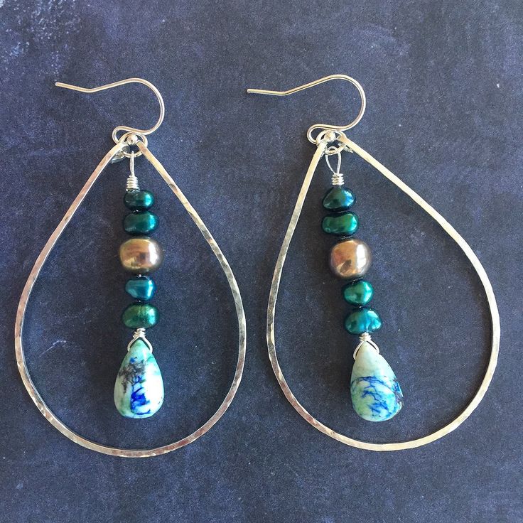 Please note all stones are unique. This is a photo of the first pair made. Arizona oyster lapis turquoise look like delightful landscapes. I have combined these unique teardrops with peacock and multicolored freshwater pearls on sterling silver. I have used my KRISTIANA hammered hoops in the medium size in sterling silver to create these hoops. The approximate length is 2.5". Please choose your earwire preference. Nickel-free Teardrop Czech Glass Jewelry, Turquoise Teardrop Czech Glass Jewelry, Green Teardrop Jewelry With Pearl Drop, Green Teardrop Pearl Drop Jewelry, Silver Teardrop Czech Glass Jewelry, Turquoise Teardrop Polished Bead Jewelry, Turquoise Teardrop Jewelry With Polished Beads, Artisan Teardrop Blue Jewelry, Teardrop Czech Glass Wire Wrapped Jewelry