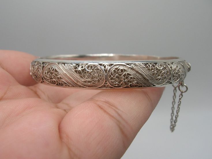 "Up for your consideration is this Vintage Sterling Silver Hinged Bangle. This bangle features an absolutely breathtakingly intricate filigree design that wraps around the entire outside of the bangle. The filigree is done so lovely and masterful. Pictures best describe. The bangle opens from the side from a box style closure and has a safety chain attached which are in perfect functioning order for a secure fit. Overall, the bracelet is in excellent condition with no dents or damage. Inside Mea Silver Bangle Bracelets Unique Antique, Filigree Bangle, Silver Jewelry Accessories, Vintage Bangle Bracelets, Filigree Bracelet, Antique Silver Jewelry, Vintage Bangles, Elephant Necklace, Safety Chain