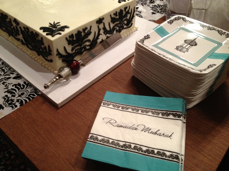 a table topped with lots of white and blue cake covered in frosting on top of plates