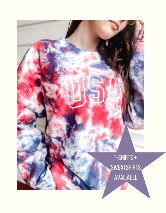 a woman wearing a red, white and blue tie dye shirt with the word usa on it