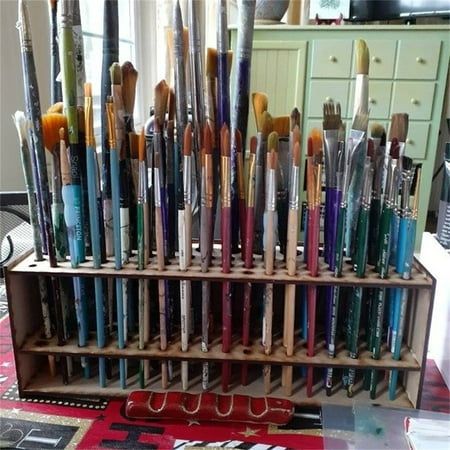 there are many different types of paintbrushes in this display case on the table