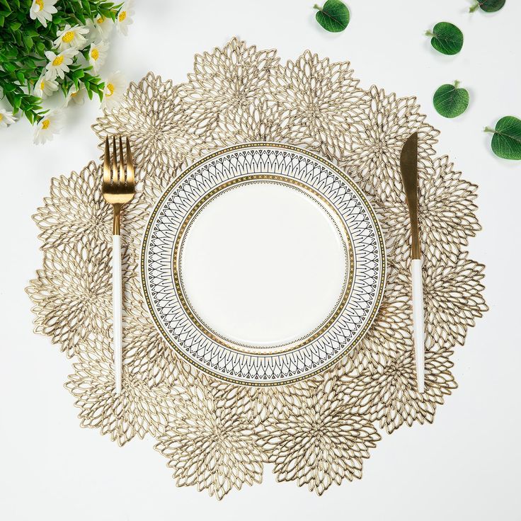 a place setting with silverware and flowers