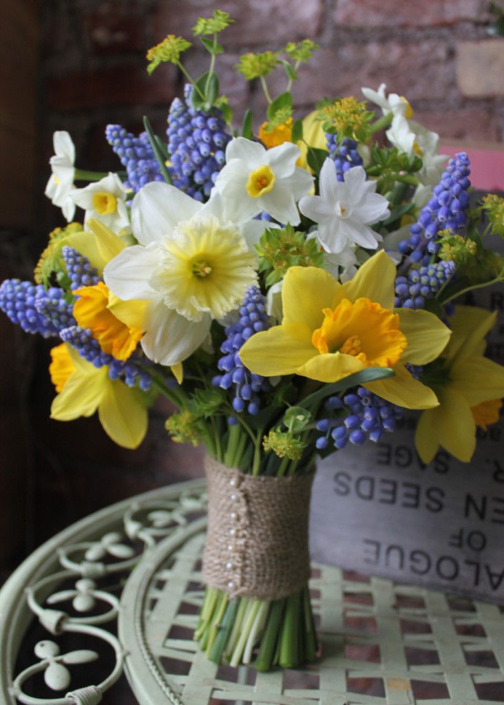 a vase filled with yellow and white flowers