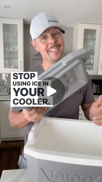 a man is holding up a cooler in his kitchen with the words stop using ice in your cooler