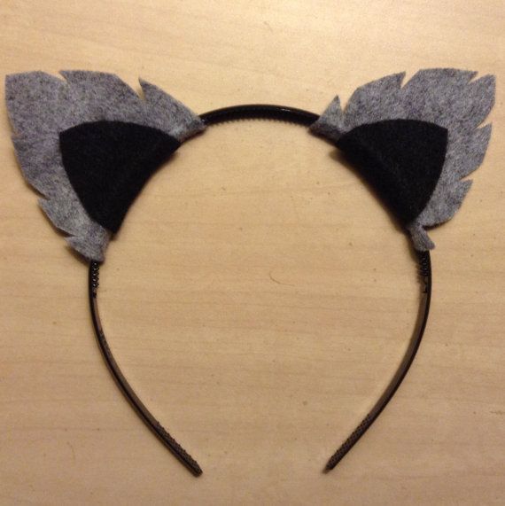 a cat ears headband made out of felt with black and grey leaves on it