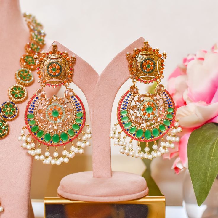 Adorn into the extravagant fusion of grace and royalty! Paint yourself in luscious shades of nauratan stones enhanced by pearl moti hanging with a classic embodiment of ravishing design radiating elegant femininity. Approximate earrings length is 4". Gold-plated on high-quality brass as base metal. Iqra Earrings (Sapphire) is in-stock & ready-to-ship. Delivery time frame for other options is 5-7 weeks. For custom or urgent requests, please contact support@alacouture.com. *Please Note: The multi- Red Kundan Jeweled Earrings, Red Jeweled Kundan Earrings, Red Kundan Dangle Jewelry, Festive Red Kundan Chandelier Earrings, Red Kundan Gemstone Necklace, Unique Gift Cards, Emerald Color, Create Words, Faux Stone