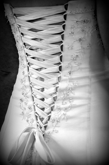 the back of a wedding dress is shown in black and white