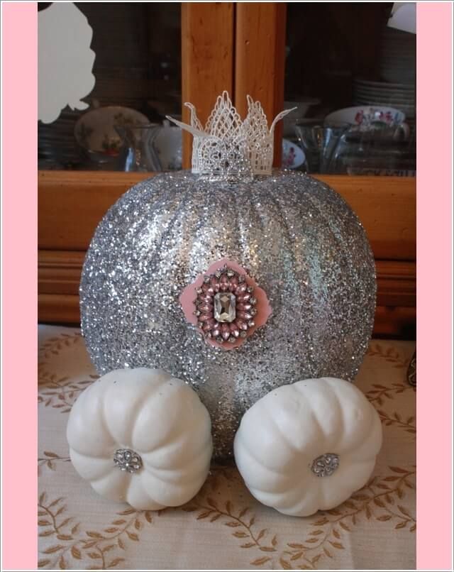 two white pumpkins sitting on top of a table next to each other with silver glitter covering them