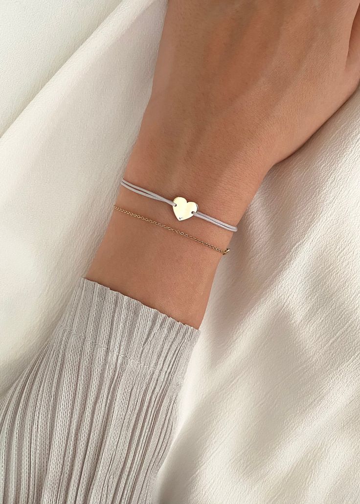 HEART BRACELET A simple symbol of love, our Heart is made from solid gold 14K, set on an adjustable string.  Add this meaningful bracelet to your collection today and let it inspire you to bring your dreams of motherhood into the world. Safe to wear all the time, including in contact with water. The solid gold charm will not get damaged, tarnish or change color. FREE SHIPPING WORLDWIDE PROCESSING TIME: 1-2 business days MATERIAL : High quality solid 14 k gold SIZE : Adjustable. Our Heart bracele Bracelet Original, Solid Gold Charms, Bracelet For Her, Gift For Valentines Day, String Bracelet, Color Free, Dainty Jewelry, Heart Bracelet, Gold Charm