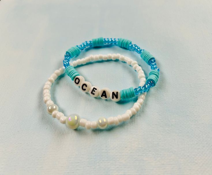 Set of two ocean inspired bracelets, made with stretchy string, friendship bracelet style Adjustable Ocean-inspired Beaded Bracelets, Ocean-inspired Beaded Bracelets With Round Beads, Ocean-inspired Beaded Round Bead Bracelets, Ocean-inspired Beaded Round Bracelets, Beaded Strand Bracelets For Friendship, White Ocean-inspired Strand Friendship Bracelets, Handmade Ocean-inspired Round Beaded Bracelet, Adjustable Ocean-inspired Friendship Bracelets, Ocean-inspired Bracelets With Colorful Beads For Gifts