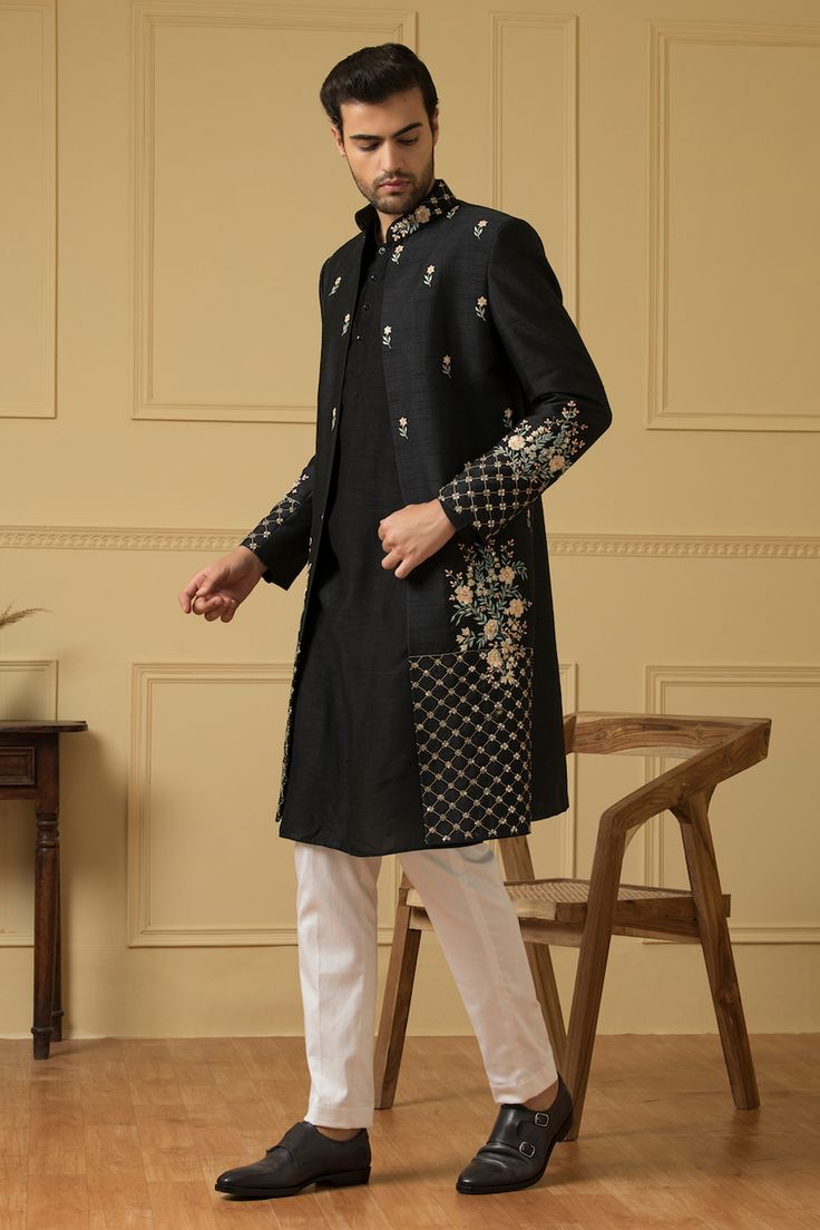 Black jacket embroidered with floral patterns embellished with cutdana and sequin. Comes with plain kurta and pant.
Components: 3
Pattern: Embroidered
Type Of Work: Cutdana,Squin
Neckline: Jacket and Kurta: Mandarin Collar
Sleeve Type: Jacket: Full
Fabric: Semi Raw Silk
Color: Black
Other Details: 
Side slits
Closure: Kurta: Button
Occasion: Sangeet,Cocktail and Reception - Aza Fashions Elegant Multicolor Embroidered Outerwear For Festive Occasions, Elegant Multicolor Embroidered Festive Outerwear, Elegant Festive Outerwear With Multicolor Embroidery, Elegant Festive Multicolor Embroidery Outerwear, Traditional Fitted Outerwear With Embroidered Sleeves, Embroidered Long Coat For Festive Occasions, Fitted Stand Collar Outerwear With Intricate Embroidery, Transitional Fitted Outerwear With Floral Embroidery, Designer Embellished Long Sleeve Sherwani