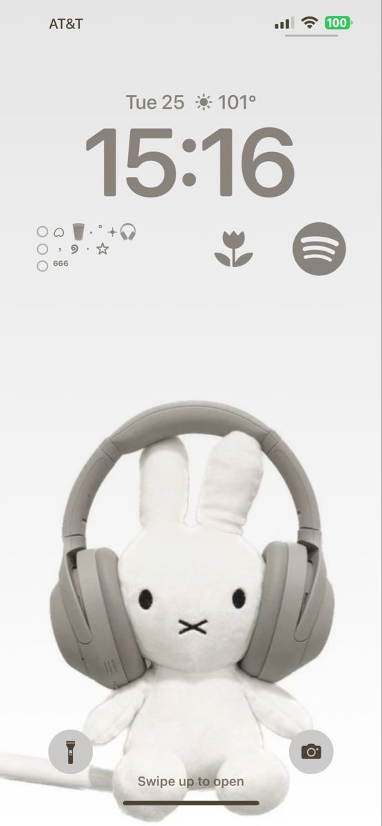 a white stuffed animal with headphones on