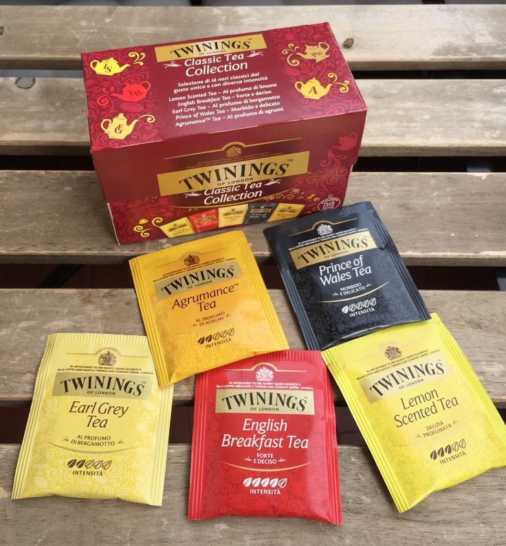 six tea bags sitting on top of a wooden bench next to a box of twinings english breakfast tea