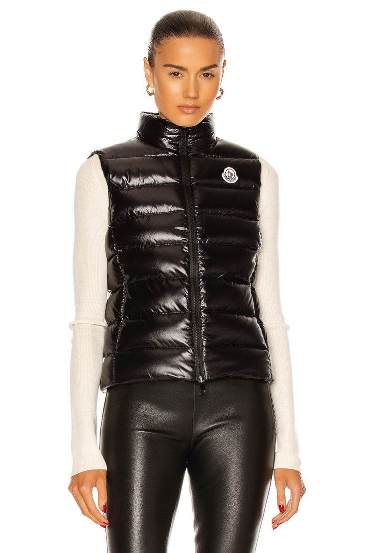 Self: 100% polyamide, Fill: 90% pure goose down 10% feathers.  Made in Moldova.  Dry clean only.  Dual zip front closure.  Hidden side zip pockets.  Embroidered logo patch at chest.  .  .  .  .  .  .  .  .  .  . Moncler Gilet, Apres Ski Style, Luxury Outerwear, Moncler Women, Slim Sweater, Puffy Vest, Ski Fashion, Outerwear Vest, Vest White