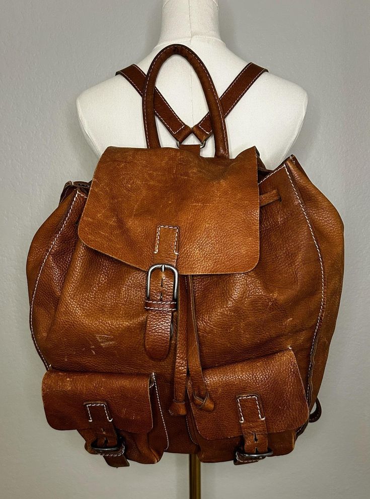 Discover the charm of this vintage Eddie Bauer leather backpack. Made in Portugal, it features sturdy brown leather, comfortable adjustable straps, and convenient internal pockets. Perfect for daily use or outdoor adventures, this backpack blends functionality with a timeless style. Vintage Leather Travel Backpack, Vintage Leather Everyday Backpack, Vintage Leather-lined Backpack, Classic Brown Backpack For Outdoor Use, Classic Brown Backpack For Outdoor, Vintage Backpack With Leather Lining For Everyday Use, Vintage Travel Backpack With Leather Handles, Vintage Brown Backpack With Leather Lining, Vintage Brown Leather Backpack For Everyday