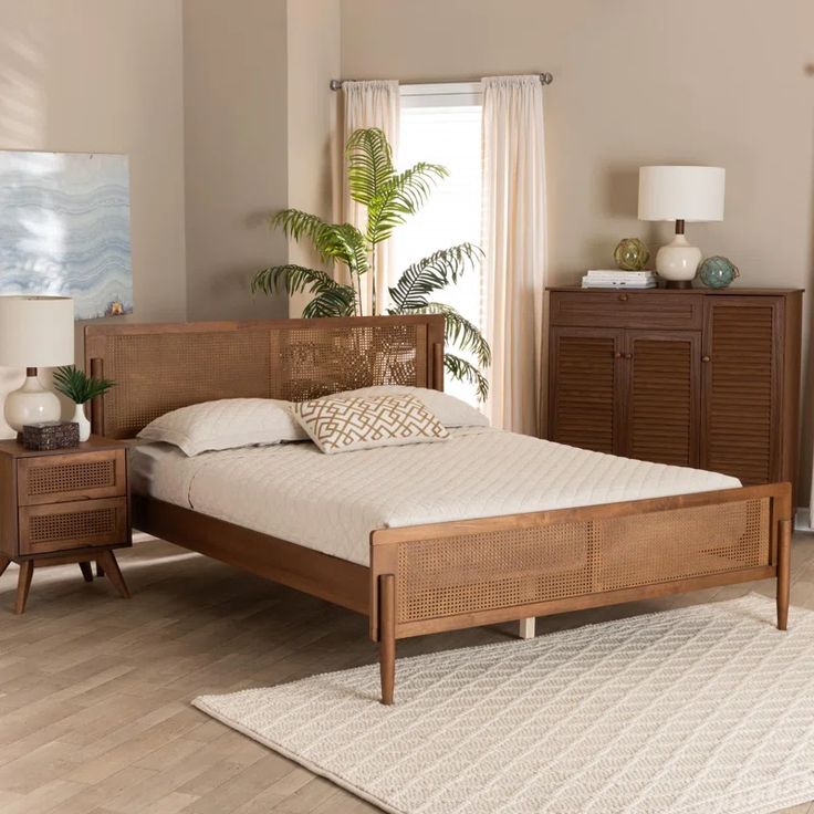 a bed sitting on top of a wooden floor next to a dresser and lamp in a bedroom