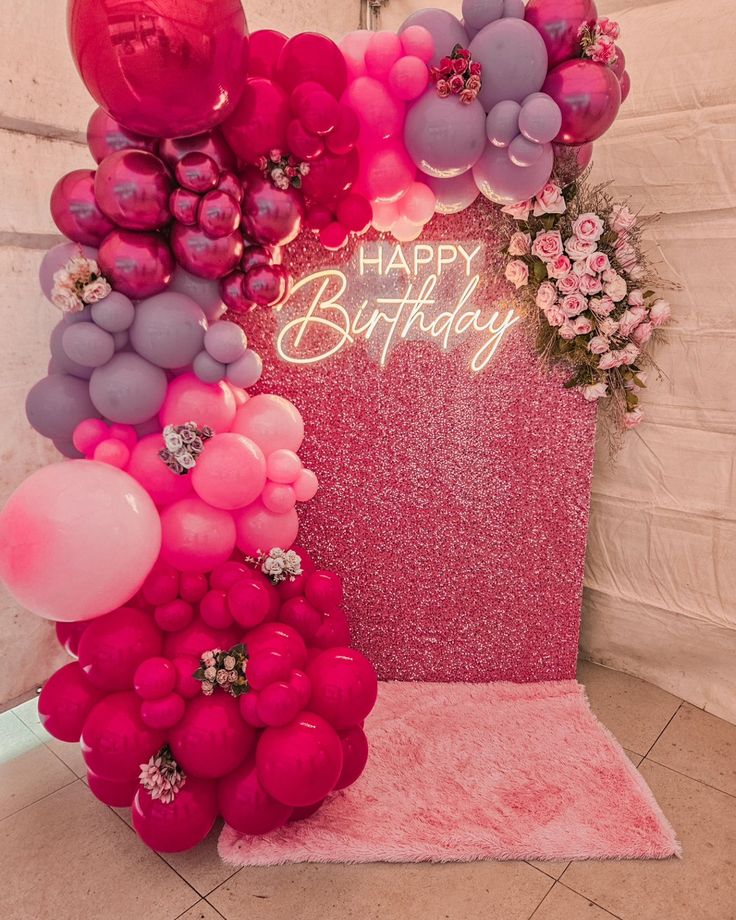 a pink and purple birthday party with balloons