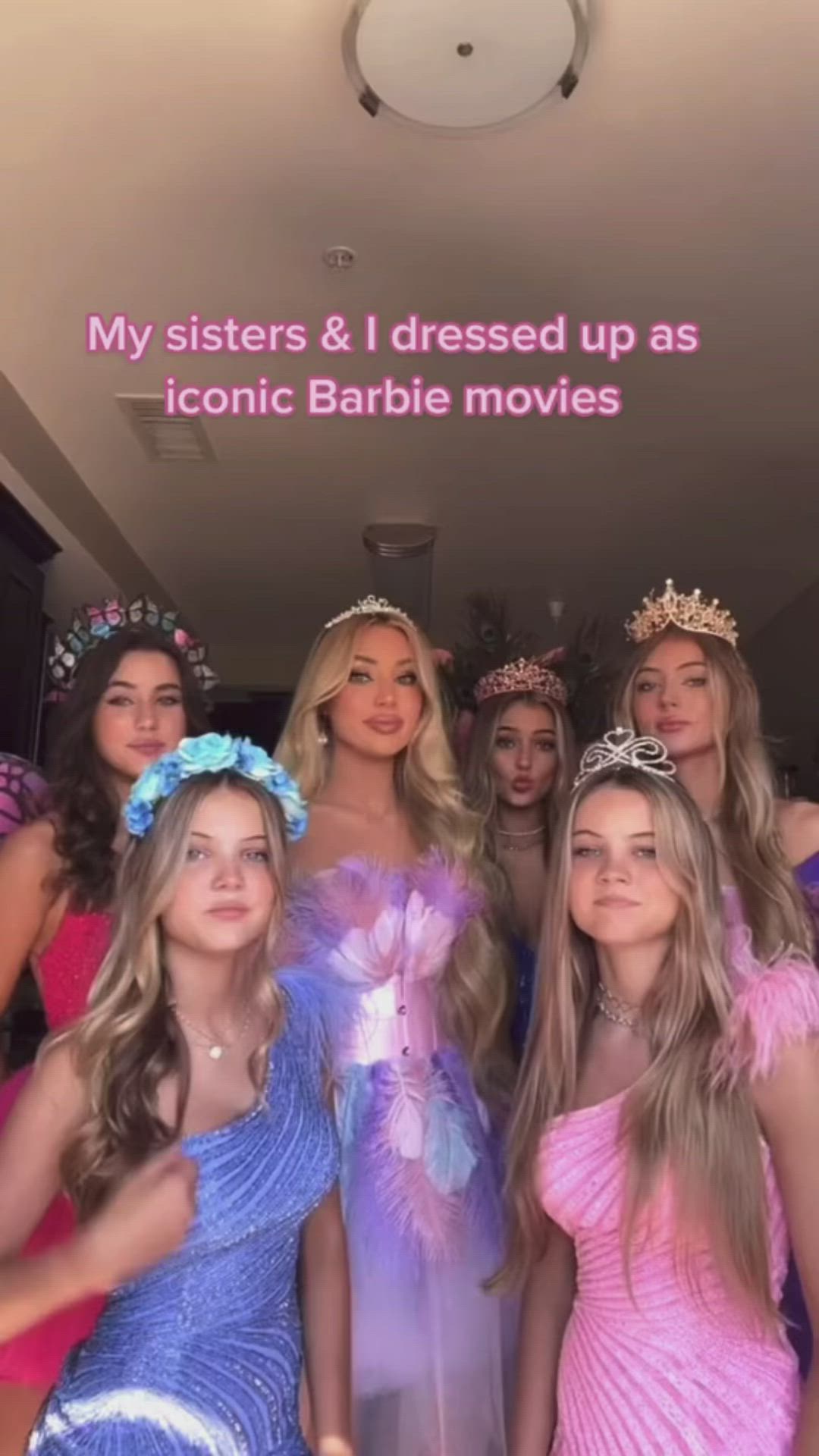 This may contain: a group of young women standing next to each other in front of a sign that says my sisters & i dressed up as iconic barbie movies