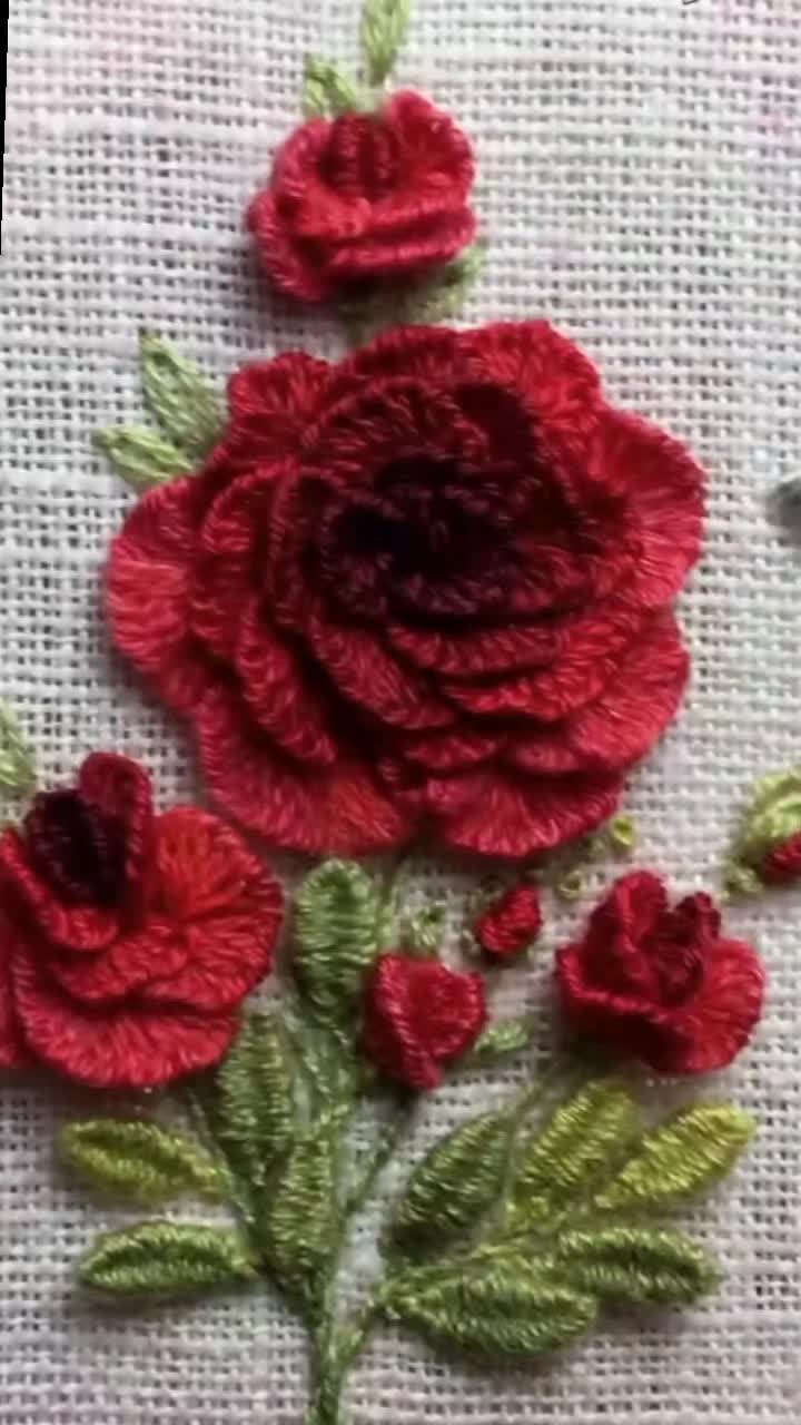 This may contain: some red flowers are on a white cloth