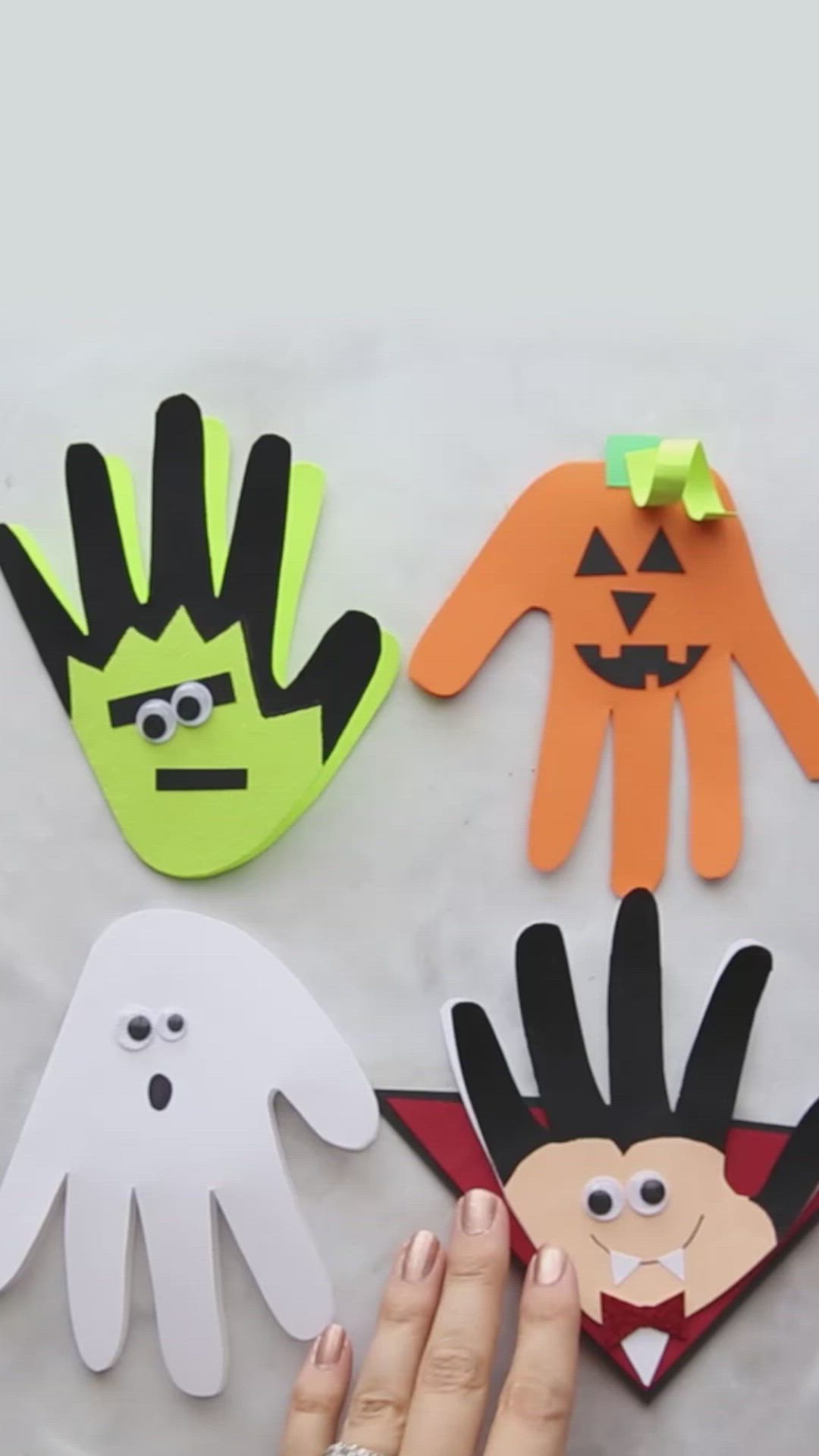 This may contain: halloween handprints made out of construction paper